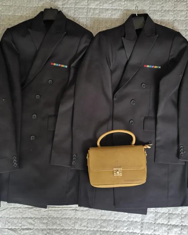 Four black tailored jackets laid out beside a tan handbag for a client order, Wears For You, Sialkot Pakistan