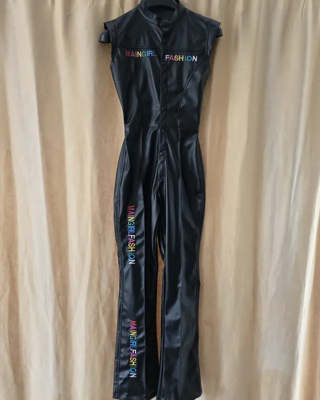 Black leather-look jumpsuit with printed detail, hanging after finishing, Wears For You, Sialkot Pakistan