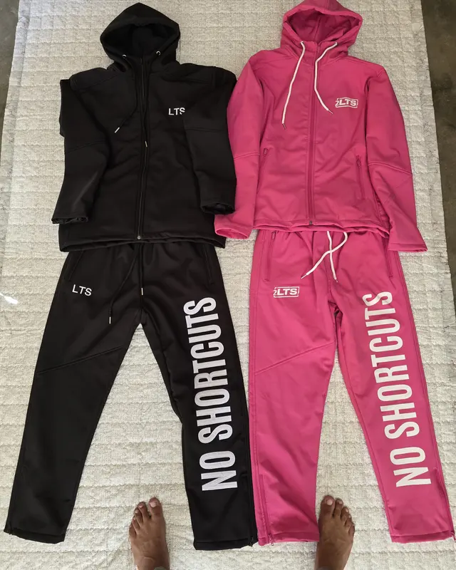 Black and pink NO SHORTCUTS tracksuit sets photographed side by side, Wears For You, Sialkot Pakistan