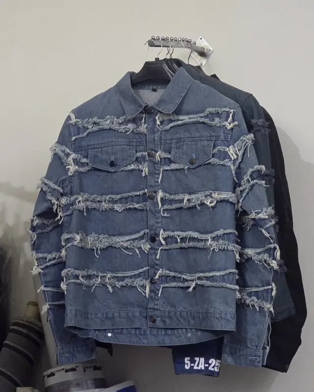 Distressed denim jacket with frayed panel detail on a hanger, Wears For You, Sialkot Pakistan