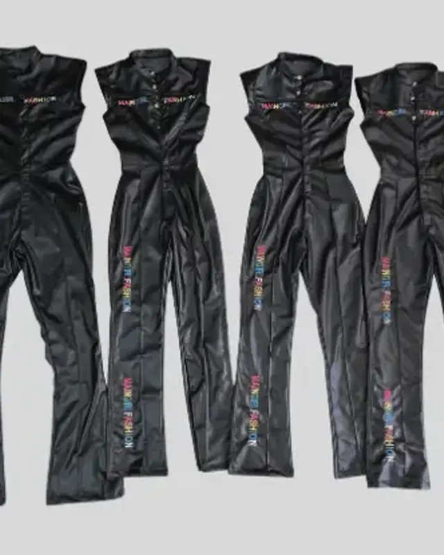 Four black leather-look jumpsuits finished and hung on a rail, Wears For You, Sialkot Pakistan