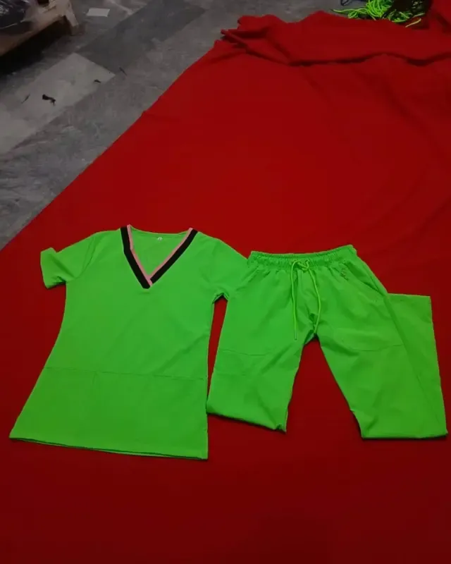 Green V-neck women’s scrub top and trousers with contrast neckline binding and a front panel seam, custom medical scrubs, Wears For You, Sialkot Pakistan