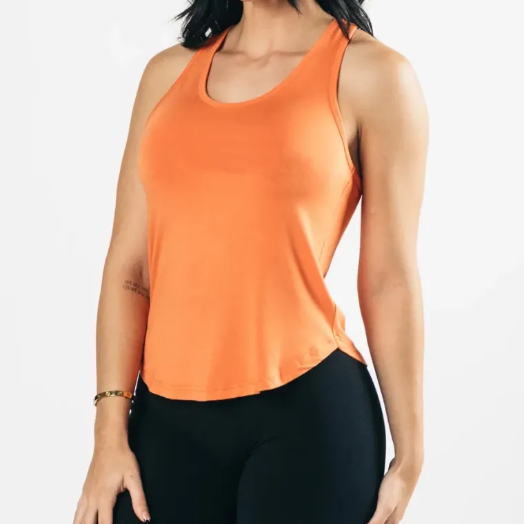 Orange women's gym tank top worn with black leggings, custom women's gym tank tops, Wears For You, Sialkot Pakistan