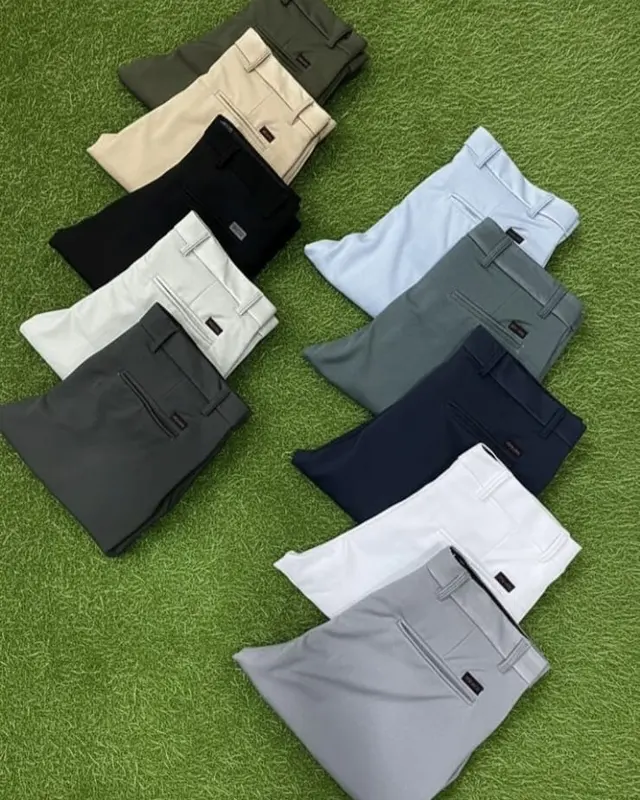 Folded tees and shorts in a full colour range on the factory turf backdrop, Wears For You, Sialkot Pakistan