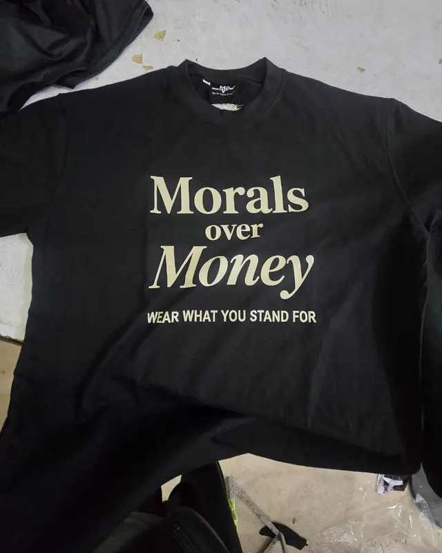 Black tee with a gold Morals Over Money screen print, custom streetwear, Wears For You, Sialkot Pakistan