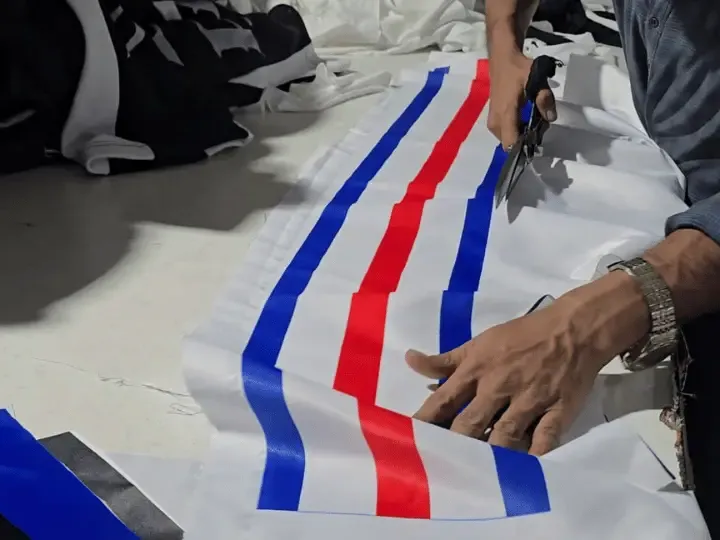 Cutting sublimated fabric panels by hand on the cutting table, OEM full package clothing manufacturing, Wears For You, Sialkot Pakistan