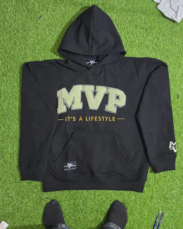 Black MVP zip hoodie with a gold print on the factory turf backdrop, Wears For You, Sialkot Pakistan