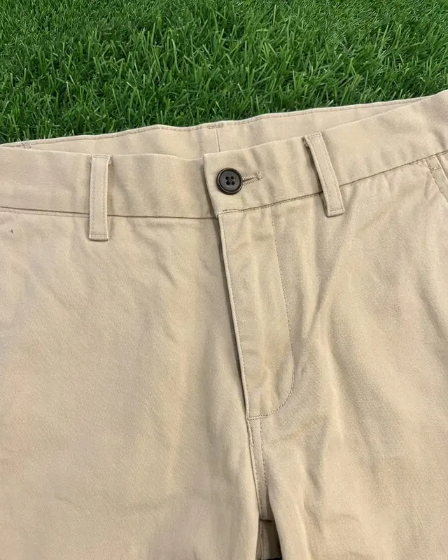Close-up of khaki chino trousers showing the button waistband and belt loops, custom trousers, Wears For You, Sialkot Pakistan