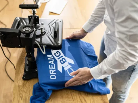 Heat press applying vinyl lettering to a garment, heat press vinyl printing, Wears For You, Sialkot Pakistan